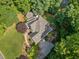 Aerial view of the property with mature trees, circular driveway, and well maintained landscaping at 210 Lawn Market, Sharpsburg, GA 30277