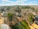 Aerial view of the home and its wooded surroundings on a lake featuring private dock and shoreline at 210 Lawn Market, Sharpsburg, GA 30277