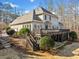 Rear exterior view featuring a deck, patio, and well-maintained landscaping perfect for outdoor living at 210 Lawn Market, Sharpsburg, GA 30277