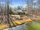 Expansive backyard with mature trees, a water feature, and a patio, ideal for outdoor entertaining at 210 Lawn Market, Sharpsburg, GA 30277