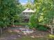 Backyard featuring stone steps leading down to a lower patio and the waterfront at 210 Lawn Market, Sharpsburg, GA 30277