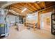 Unfinished basement with exposed beams, shelving, and a workbench area at 210 Lawn Market, Sharpsburg, GA 30277