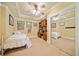 Cozy bedroom with a ceiling fan, built-in shelving, and mirrored closet doors at 210 Lawn Market, Sharpsburg, GA 30277