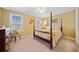 Comfortable bedroom with a four poster bed, carpet flooring, and natural light streaming in through the windows at 210 Lawn Market, Sharpsburg, GA 30277
