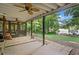 Spacious covered patio next to grassy backyard and lake offers serene setting for outdoor relaxation at 210 Lawn Market, Sharpsburg, GA 30277