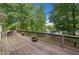 Wooden deck with outdoor seating overlooking lush greenery and a lake at 210 Lawn Market, Sharpsburg, GA 30277