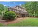 Expansive home exterior featuring a large deck and lush greenery at 210 Lawn Market, Sharpsburg, GA 30277