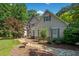Beautiful home with a combination of stone and siding surrounded by mature trees at 210 Lawn Market, Sharpsburg, GA 30277