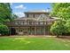 Rear exterior with large deck, screened patio, and well-maintained lawn at 210 Lawn Market, Sharpsburg, GA 30277