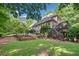 Landscaped backyard with stone steps, planting beds, and lush foliage at 210 Lawn Market, Sharpsburg, GA 30277