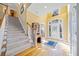 Welcoming foyer with staircase, hardwood floors, and a decorative glass front door at 210 Lawn Market, Sharpsburg, GA 30277