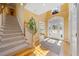Elegant foyer with hardwood floors, staircase, and view of the front door at 210 Lawn Market, Sharpsburg, GA 30277