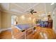 Basement game room with a ping pong table, hardwood floors, and a full wet bar at 210 Lawn Market, Sharpsburg, GA 30277