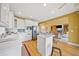 Well-lit kitchen with stainless steel appliances and open to living room at 210 Lawn Market, Sharpsburg, GA 30277