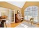 Well lit piano room featuring hardwood floors, a piano, and large windows at 210 Lawn Market, Sharpsburg, GA 30277