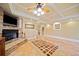 Spacious living room with a stone fireplace, a ceiling fan, and tile flooring at 210 Lawn Market, Sharpsburg, GA 30277