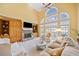Comfortable living room with stone fireplace, built-in shelving, and abundant natural light at 210 Lawn Market, Sharpsburg, GA 30277
