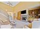 Warm and inviting living room with fireplace, built-in shelves, and staircase at 210 Lawn Market, Sharpsburg, GA 30277