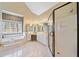 Bright main bathroom featuring a glass-enclosed shower, soaking tub, and vanity with ample counter space at 210 Lawn Market, Sharpsburg, GA 30277