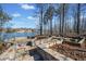 Stone patio and water feature creating a tranquil outdoor space for relaxation and entertainment with wooded views at 210 Lawn Market, Sharpsburg, GA 30277
