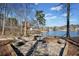 Stunning stone patio with a fountain and lake view, surrounded by trees at 210 Lawn Market, Sharpsburg, GA 30277