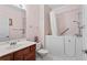 Well-lit bathroom features a walk-in tub, vanity with sink, and modern fixtures at 235 Tara Woods Dr, Riverdale, GA 30274