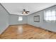 Spacious bedroom featuring hardwood floors, a ceiling fan, and natural light from two windows at 2864 Saint Andrews Ne Way, Marietta, GA 30062