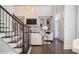 Elegant staircase leads to a living area featuring a fireplace and custom built-ins at 3172 Ashford Dunwoody Ne Rd, Brookhaven, GA 30319