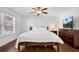 Bright bedroom featuring a ceiling fan, a window with blinds, and wood furnishings at 4037 Plantation Dr, Marietta, GA 30062