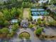 Overhead view of community amenities featuring pool, tennis courts, clubhouse, and lush green spaces at 423 Treetop Cir, Canton, GA 30115