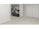 Basement gym featuring an elliptical machine, a treadmill, and sliding barn doors that lead to the bedroom at 423 Treetop Cir, Canton, GA 30115