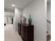 Basement hallway featuring neutral carpeting, a decorative dresser, and an entrance to the finished basement at 423 Treetop Cir, Canton, GA 30115