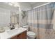 Clean bathroom with a single sink vanity, floral decorations, and a patterned shower curtain at 423 Treetop Cir, Canton, GA 30115