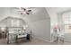 Bright bedroom featuring a metal bed frame, ceiling fan, and a vanity table with a stool at 423 Treetop Cir, Canton, GA 30115