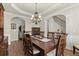 Beautiful dining area boasts hardwood floors, wainscoting, and a large table with seating for eight at 423 Treetop Cir, Canton, GA 30115