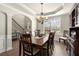 Formal dining room featuring a chandelier, large window, and beautiful hardwood floors at 423 Treetop Cir, Canton, GA 30115