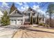 Charming two-story home featuring a manicured lawn, two-car garage and beautifully landscaped front yard at 423 Treetop Cir, Canton, GA 30115