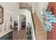 Elegant foyer showcasing hardwood floors, staircase, and an open layout with abundant natural light at 423 Treetop Cir, Canton, GA 30115