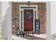 Inviting front entrance with decorative wreath, stacked stone wall, and a welcoming 