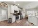 Bright eat-in kitchen features stainless steel appliances, sleek white cabinets and countertops, and hardwood floors at 423 Treetop Cir, Canton, GA 30115