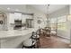 An eat-in kitchen features stainless steel appliances, sleek white cabinets and countertops, and hardwood floors at 423 Treetop Cir, Canton, GA 30115