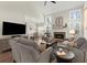 Spacious living room featuring a stone fireplace, multiple windows, and an open concept design at 423 Treetop Cir, Canton, GA 30115