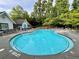 Community pool, featuring crystal clear water, lounge chairs, and a covered seating area, with trees in the background at 423 Treetop Cir, Canton, GA 30115