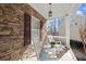 Cozy front porch features classic rocking chairs, stacked stone wall, and a charming outdoor seating area at 423 Treetop Cir, Canton, GA 30115