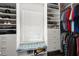 Organized walk-in closet with custom shelving, drawers, and bench seating under a bright window at 423 Treetop Cir, Canton, GA 30115