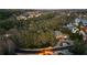 Expansive aerial view of a luxury estate nestled among mature trees with lake views at 1050 Carnoustie Ln, Alpharetta, GA 30005