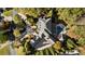Aerial view showcases this home's unique roofline, patio, pool and lush landscaping at 1050 Carnoustie Ln, Alpharetta, GA 30005