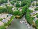 Aerial view of a lakeside community with private boat docks and mature trees at 1050 Carnoustie Ln, Alpharetta, GA 30005