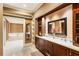 Luxurious bathroom with double vanity, marble floors, and a view of the soaking tub in the adjacent room at 1050 Carnoustie Ln, Alpharetta, GA 30005