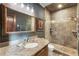 Bathroom featuring a walk-in shower, granite countertops, and dark gray walls at 1050 Carnoustie Ln, Alpharetta, GA 30005